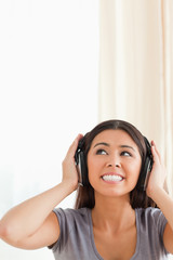 cute woman with earphones looking up