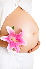Pregnant woman holding lillies isolated on white