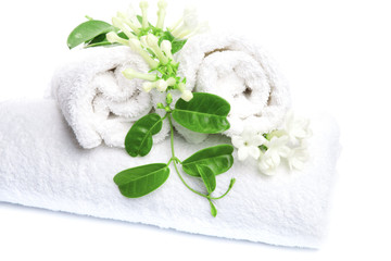 Obraz na płótnie Canvas White towels with white flowers for wellness
