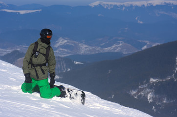 Fototapeta na wymiar The snowboarder is sitting on the brink of a precipice.