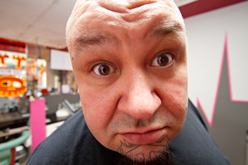portrait of a funny man with tattoo on a chin