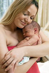 Obraz na płótnie Canvas Beautiful young mother and her newborn baby boy