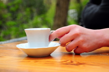 hand holding coffee glass