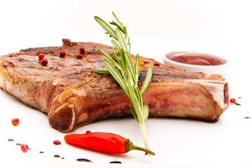Closeup of grilled steak with peper corns and rosemary