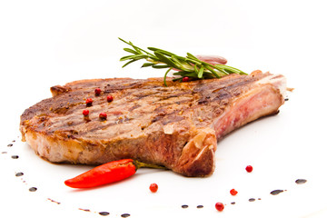 Closeup of grilled steak with peper corns and rosemary