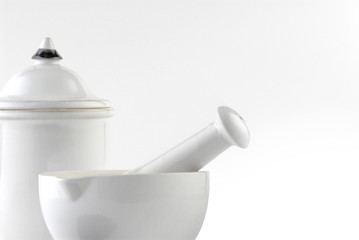 White ceramic mortar and pestle on white background.