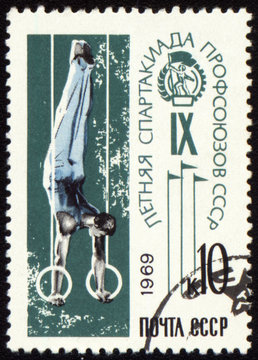 Post stamp shows gymnast on rings