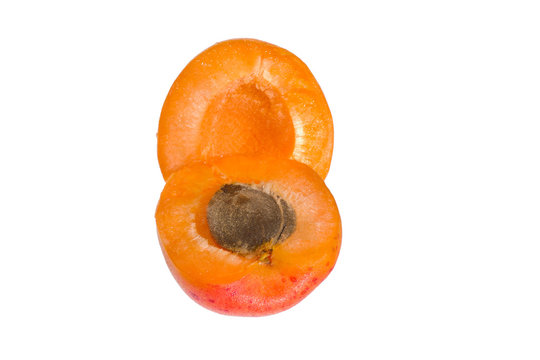 Two lobules of an apricot isolated on a white background.