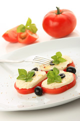 Obraz na płótnie Canvas Served tomato with mozzarella and basil