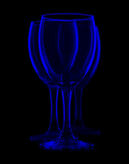 three empty wine glasses on black