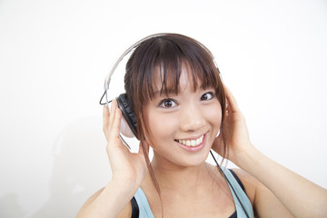 Fototapeta premium ヘッドフォンで音楽を聴く女性