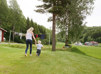 Woman and child walking in garden