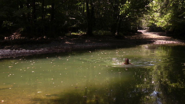 girl swim in the backwaters of mountain stream