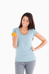 Beautiful woman holding an orange