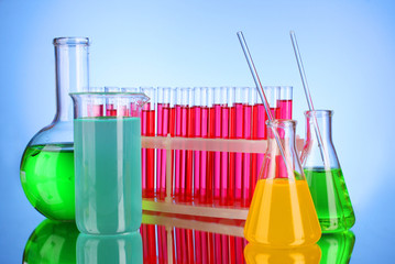 Laboratory glassware on blue background