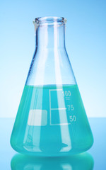 Conical flask on blue background
