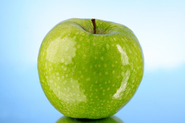 green apple on blue background
