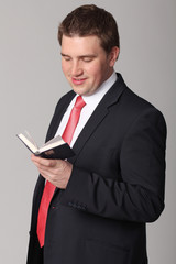 young businessman standing against isolated white background