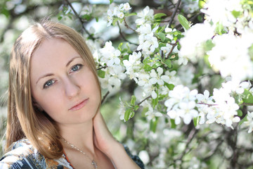 Fototapeta premium Portrait of beautiful blond in spring blossom