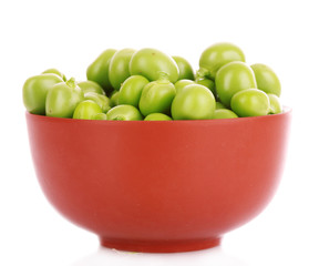 green peas in a brown bowl, isolated on white