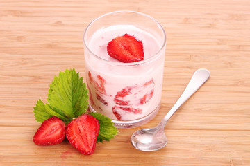 yogurt and strawberry on a wooden background