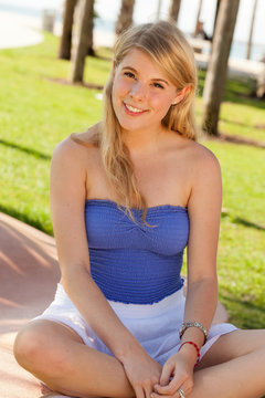 Pretty young blond woman outdoors at a park