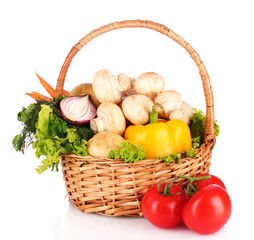 A set of vegetables in wricker basket isolated on white