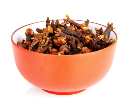 spice cloves in a bowl isolated on white