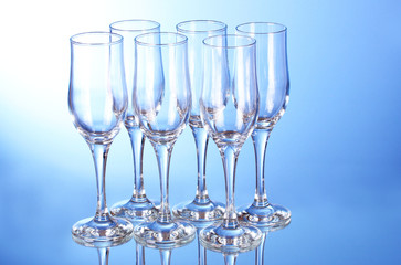 Few empty wine glasses on blue background