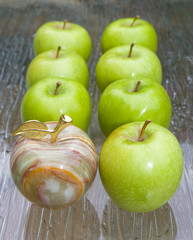 Group of green fresh apples with gemstone apple among them