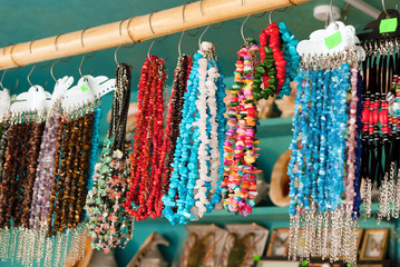 A variety of jewelry in the shop of souvenirs.
