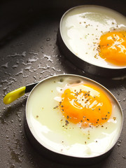 close up of fried eggs in a pan