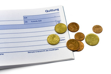 receipt with euro coins and ball-pen