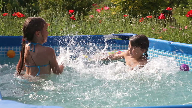 Kids have fun swimming in a pool with nice blue water