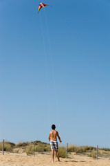 Fototapeta na wymiar little boy is holding kite on the beach