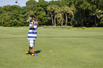 young boy golfing