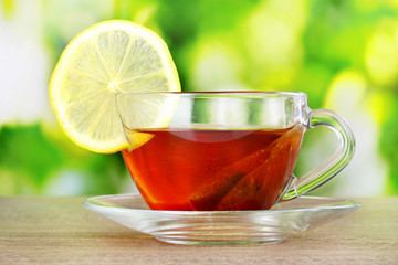 tea with lemon on green background