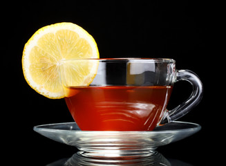 tea with lemon on black background