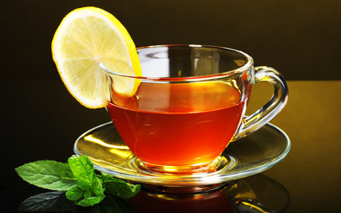 tea with lemon and mint on yellow background
