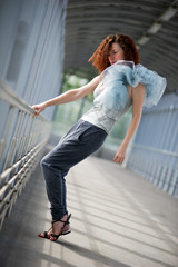 Young girl posing in a covered walkway