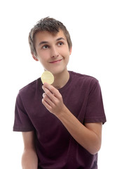 Boy with potato crisp looking sideways