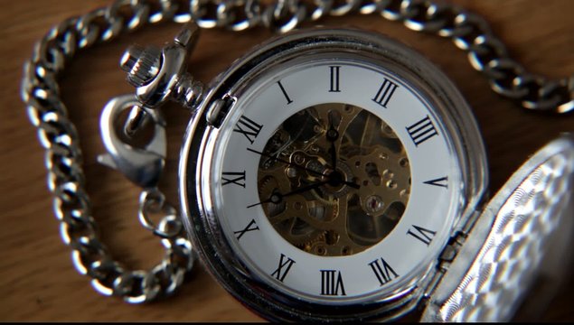 Old silver pocket watch with the second hand moving.