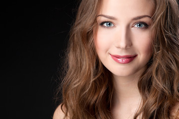 Naklejka premium Closeup portrait of beautiful female fashion model on black