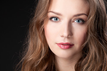 Obraz premium Closeup portrait of beautiful female fashion model on black