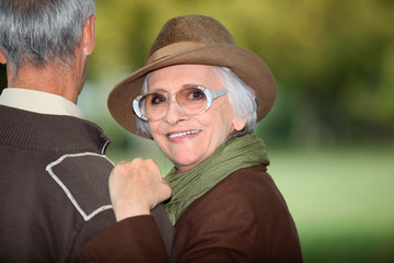 Woman with her arm on her husband's shoulder