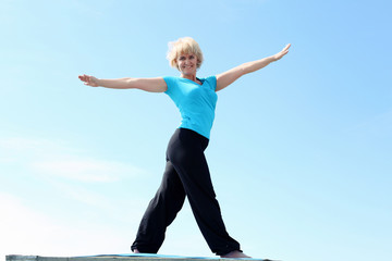 Fototapeta premium Portrait of a senior woman doing yoga