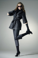 High fashion model in autumn/winter clothes wearing sunglasses