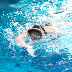 Swimmer woman performing the crawl stroke