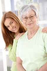 Senior mother and daughter smiling