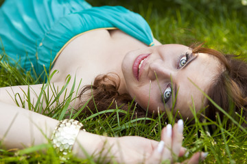 Pretty girl relaxing outdoor in green grass